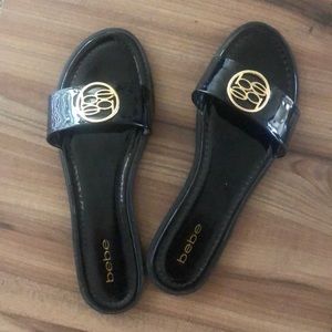 Size 10. Bebe patten leather slides.